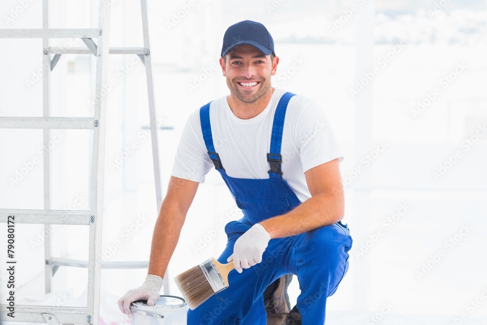 Handyman with paintbrush and can at home Handyman with paintbrush and can at home