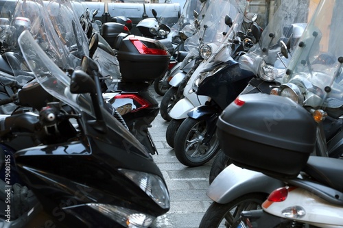 scooters and mopeds parked in illegal parking photo