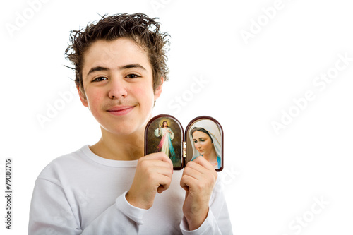 Boy holding Merciful Jesus and Our Lady of Medjugorje icons photo