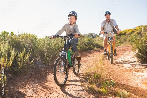 Fototapeta Naklejka Na Ścianę i Meble -  Father and son on a bike ride