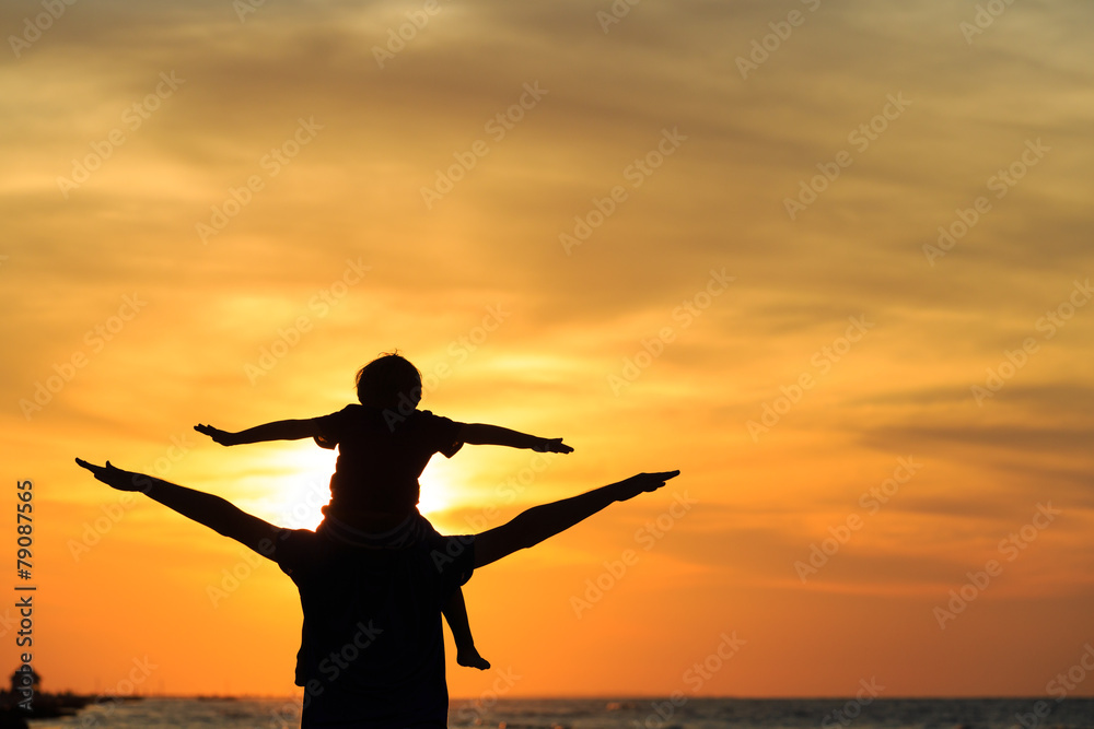 father and son having fun on sunset