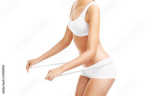 Fit woman with tape measure