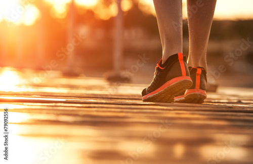 women's feet at the start of the race. concept, sunset