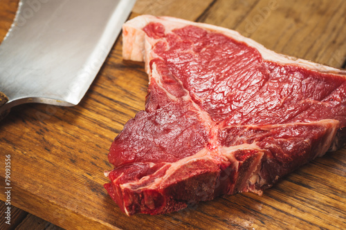 Beautiful and juicy steak on wooden board with cleaver