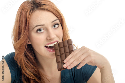 Happy woman eating a yummy chocolate and having some sugar