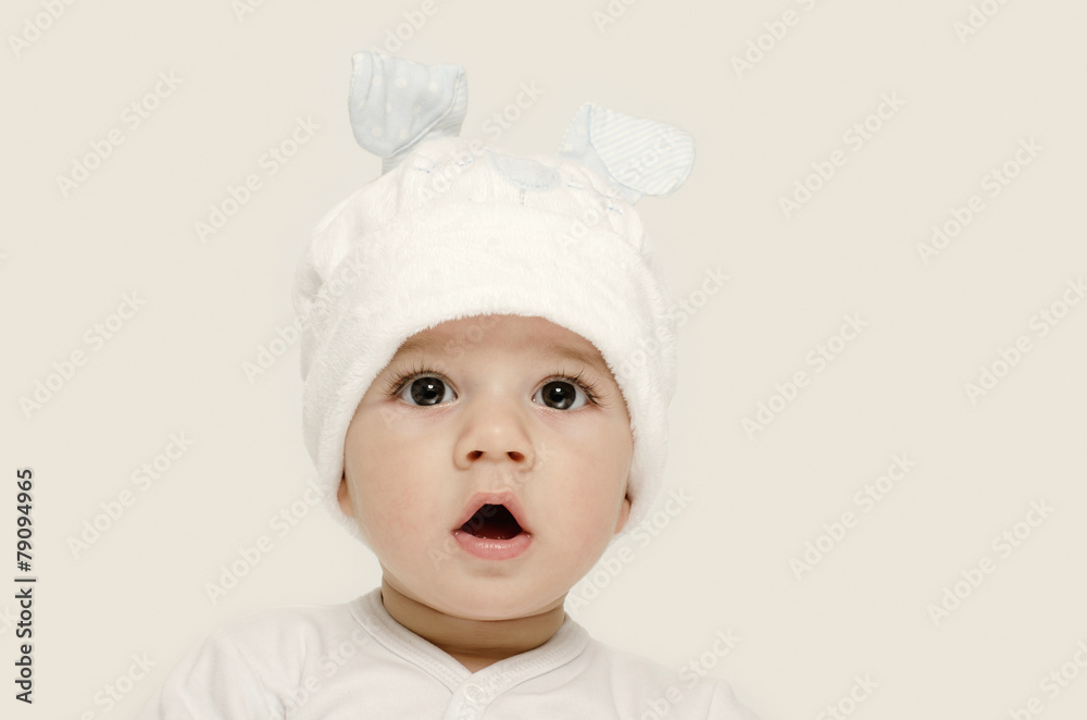 Innocent baby wearing a white bunny hat looking adorable. Innocent baby wearing a white bunny hat looking adorable.