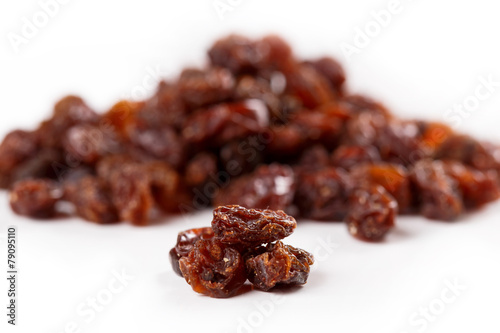 Heap of sultana raisins on white background