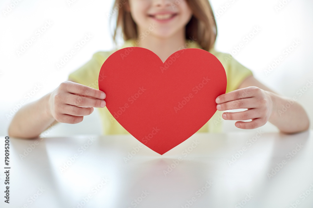 close up of child hands holding red heart close up of child hands holding red heart