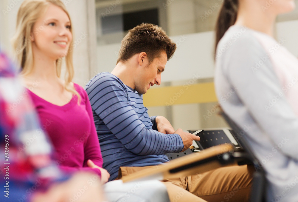 group of smiling students in lecture hall group of smiling students in lecture hall
