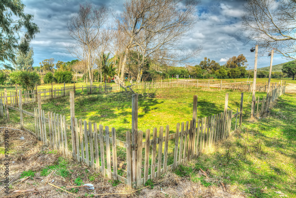 wooden fence in a green field in hdr wooden fence in a green field in hdr