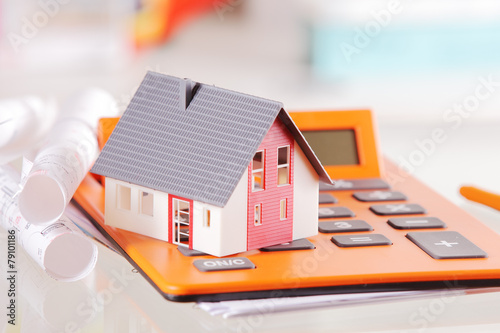 Conceptual Miniature Home on a Calculator Device photo