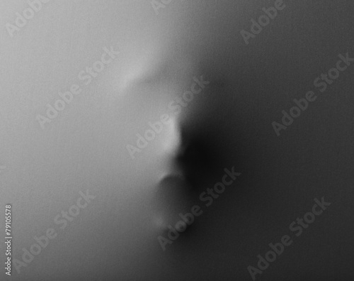 Fotografie Screaming human face pressing through fabric as horror