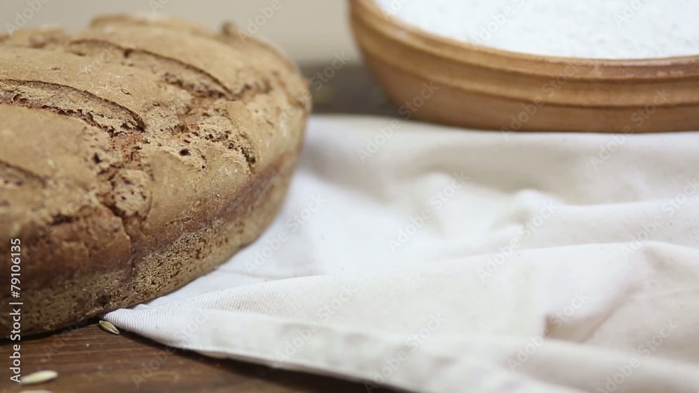 Freshly baked organic sourdough rye bread on wooden table Freshly baked organic sourdough rye bread on wooden table