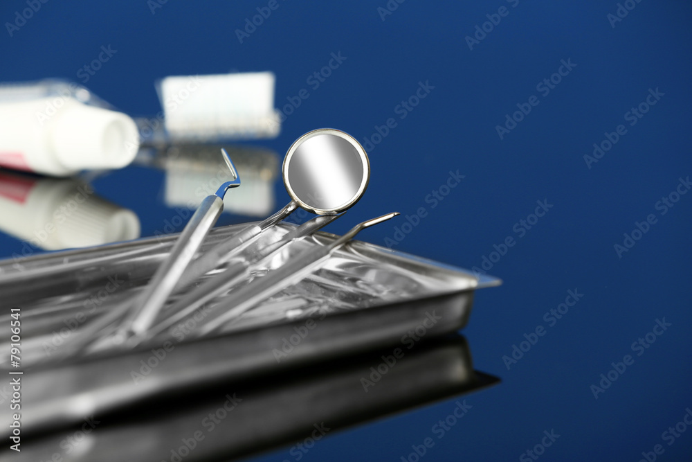 Dentist tools in metal tray with toothpaste and brush