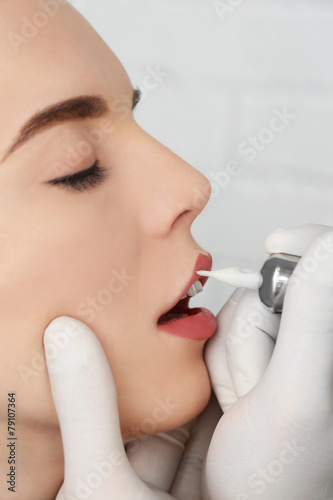 Cosmetologist making perman...
