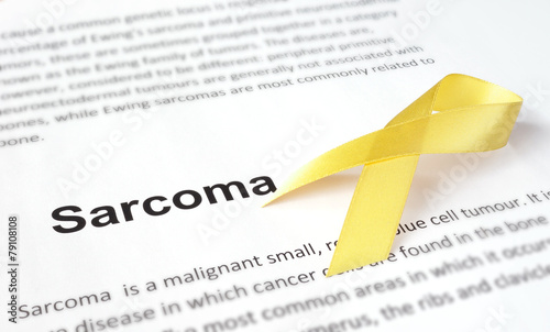 Paper with sarcoma   and yellow ribbon. photo