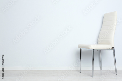 Modern chair on white wall background