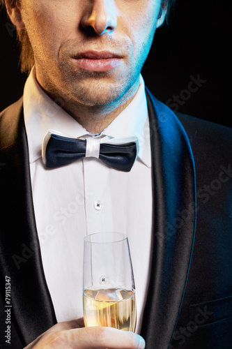 Handsome young guy drinking a champagne