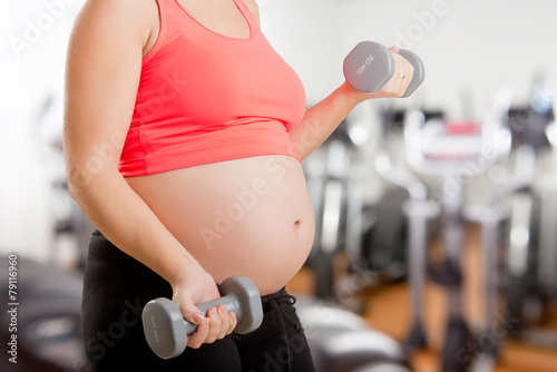 Pregnant Woman Working Out With Dumbbells