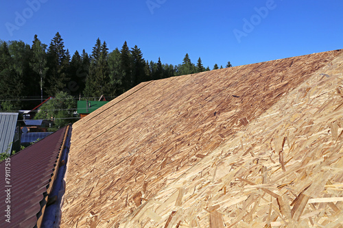 Covering the roof of a wooden house a metal tile