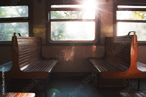 Couple of benches in train. Journey by rail. Train interior. Sunlight