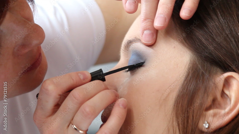 Makeup artist applying black eye liner to model eye. Full HD Makeup artist applying black eye liner to model eye. Full HD