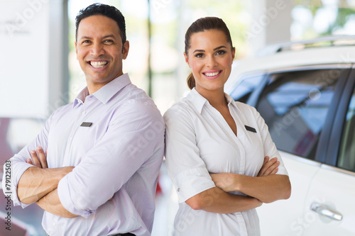 sales staff standing in vehicle showroom © michaeljung