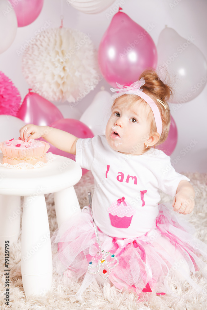Fototapeta premium Cute baby eating the birthday cake