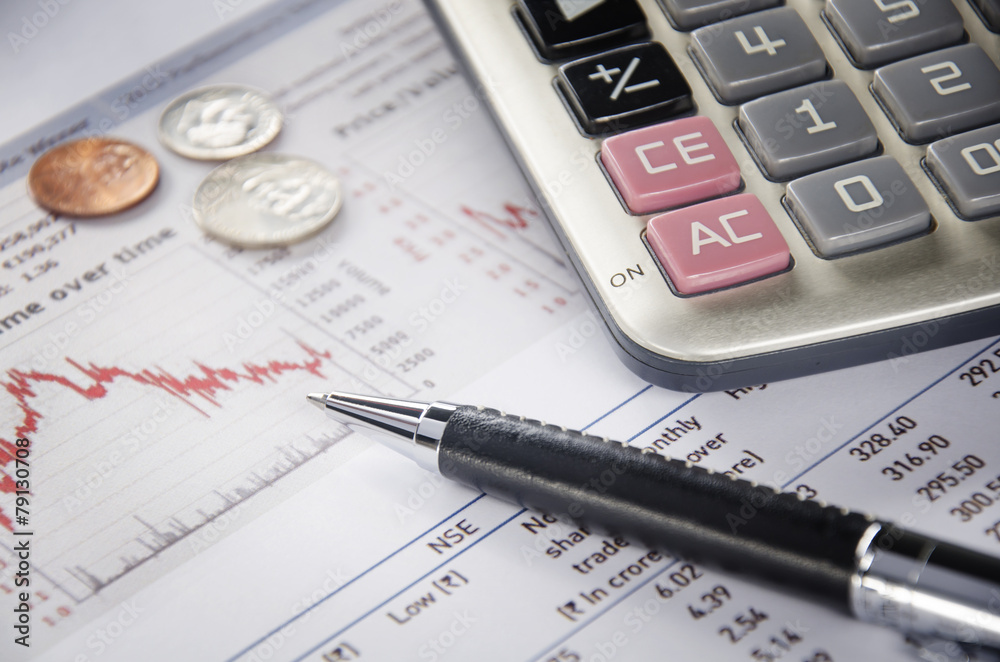 US coins and calculator on financial figure US coins and calculator on financial figure