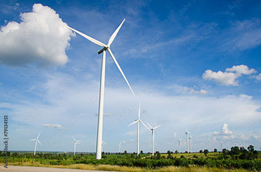 wind turbine against cloudy blue sky background