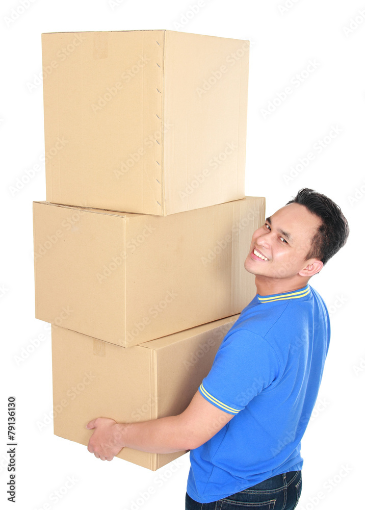 young man carrying stack of cardboxes young man carrying stack of cardboxes