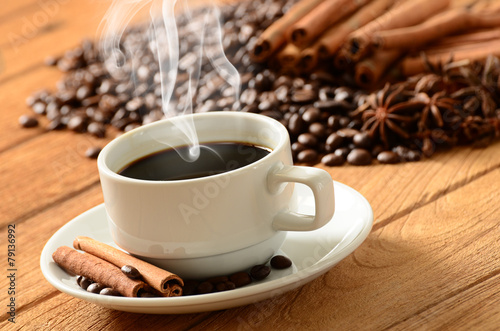 Coffee cup with smoke and coffee beans around