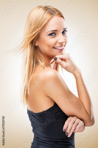 Beautiful blonde woman seductively viewer - light background