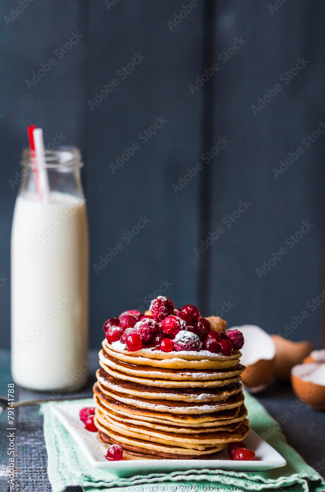 Pancake with cranberries, raspberries, honey and powdered sugar Pancake with cranberries, raspberries, honey and powdered sugar