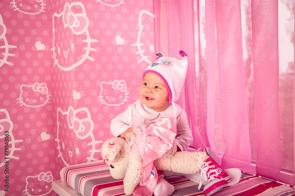 little girl in a hat sitting on a colorful windowsill, kitty little girl in a hat sitting on a colorful windowsill, kitty