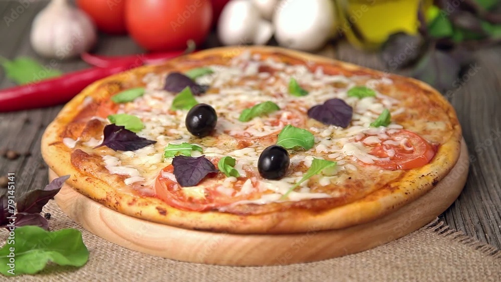 Unrecognizable woman is putting olives on pizza margherita Unrecognizable woman is putting olives on pizza margherita