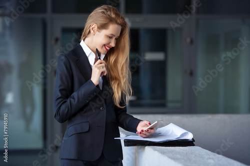 portrait of a business woman with a pen on the background of the photo