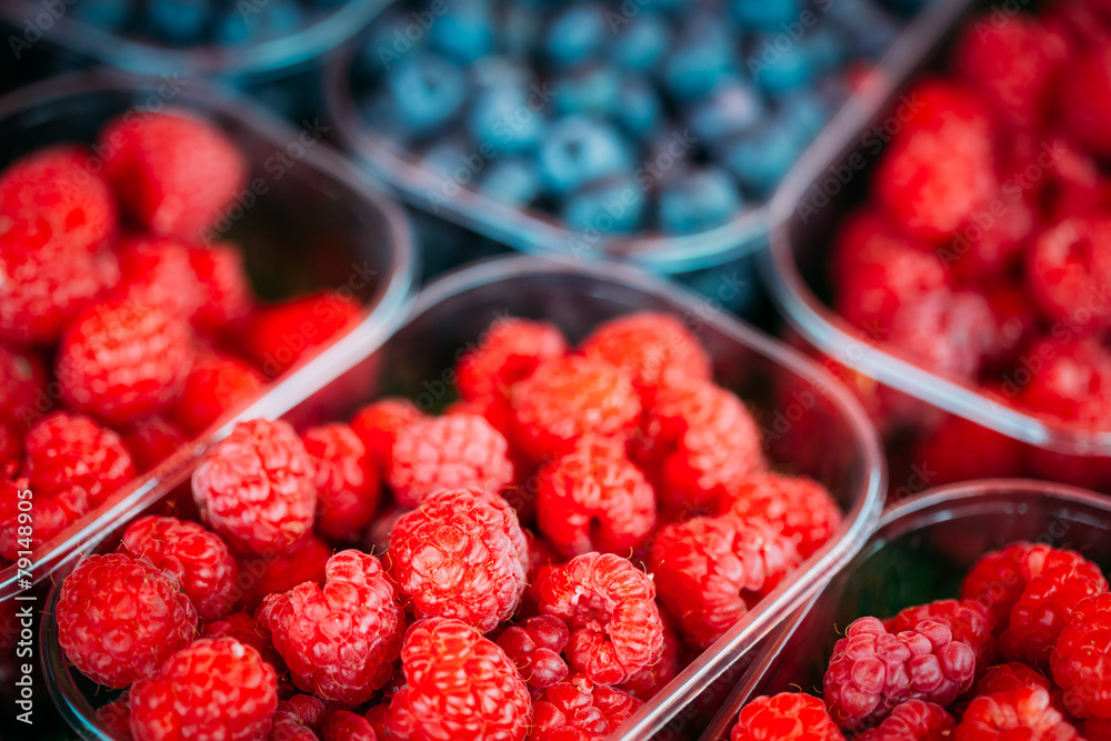 Baskets Full Of Raspberries And Blueberries On The Farmers Marke Baskets Full Of Raspberries And Blueberries On The Farmers Marke