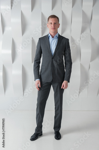 Smiling Business man full lenght in modern urban office
