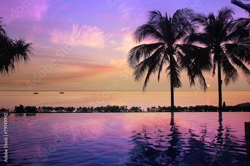 Fototapeta Naklejka Na Ścianę i Meble -  sunset sea beach palms pool
