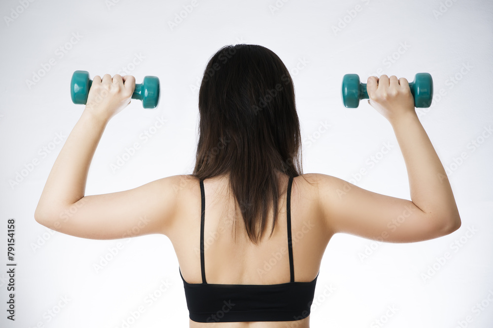 Young woman doing exercises with dumbbells Young woman doing exercises with dumbbells