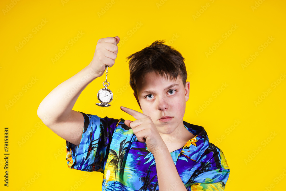 Affective teenage boy with watch showing time Affective teenage boy with watch showing time