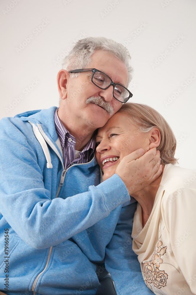 Happy smiling senior couple enjoys hugs in your home Happy smiling senior couple enjoys hugs in your home