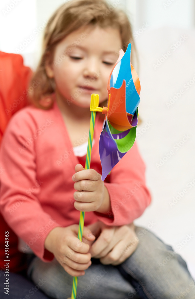 happy little girl with mother holding pinwheel toy happy little girl with mother holding pinwheel toy