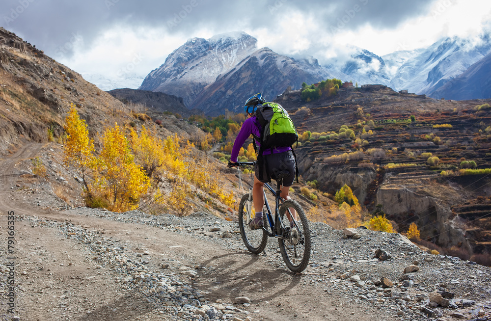 Fototapeta premium Biker-girl in Himalaya mountains, Anapurna region