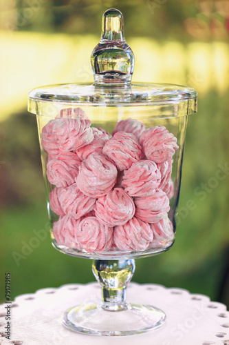 Marshmallow in a glass bowl on vivid background photo