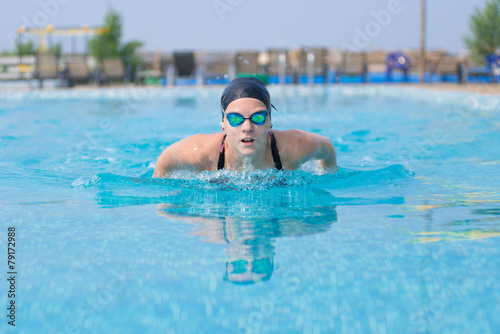 Young girl swimming butterfly stroke style