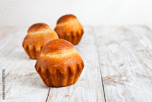 Brioche on a white wood background.