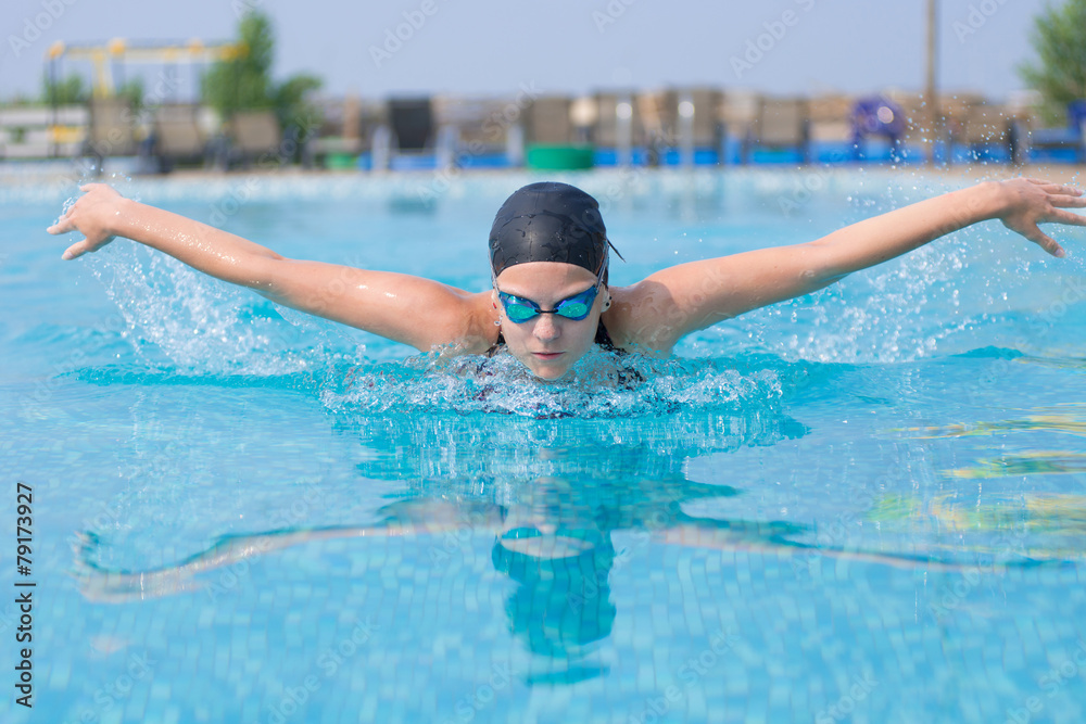 Young girl swimming butterfly stroke style