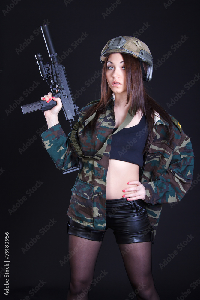 Portrait of a woman in a military uniform with a submachine gun Portrait of a woman in a military uniform with a submachine gun